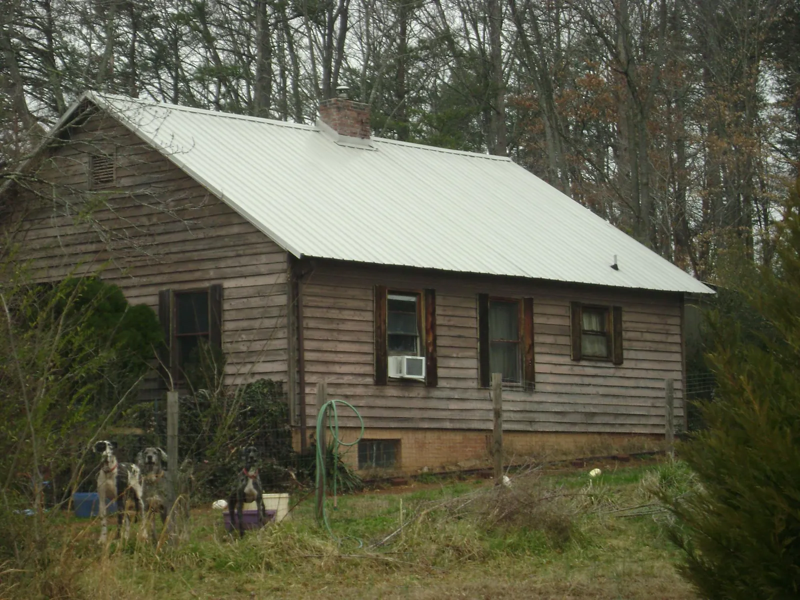 White metal roof on an old wood sided farmhouse, from a Metal Roof Installation job in Pound Ridge